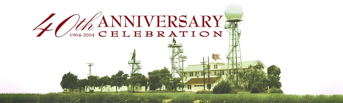 Photo of two-story woodframe building surrounded by radar towers; text reads 40th anniversary celebration 1964-2004