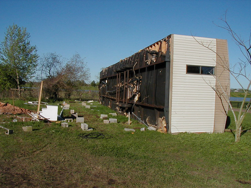 Mobile home that has been blown over by straight line winds
