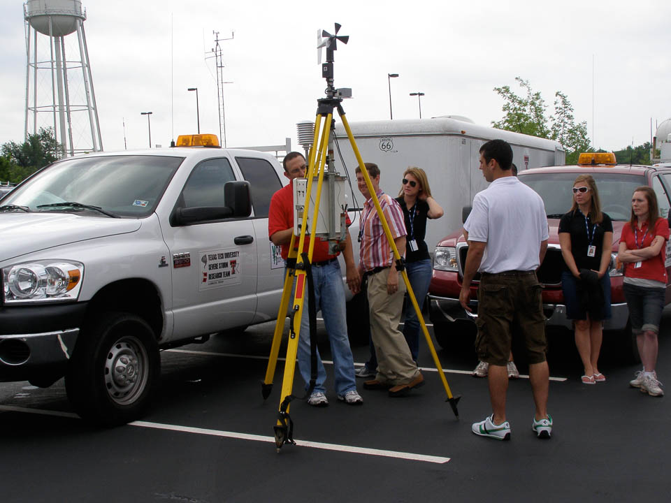 Group of people around a Sticknet in a parking lot