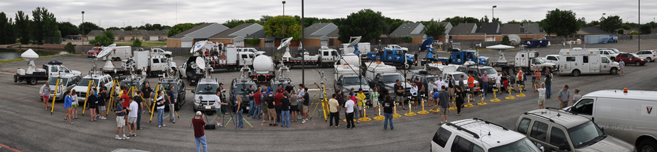 panoramic photo of vehicle armada and crew